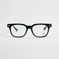 Black eyeglasses with decorative elements on a light gray background