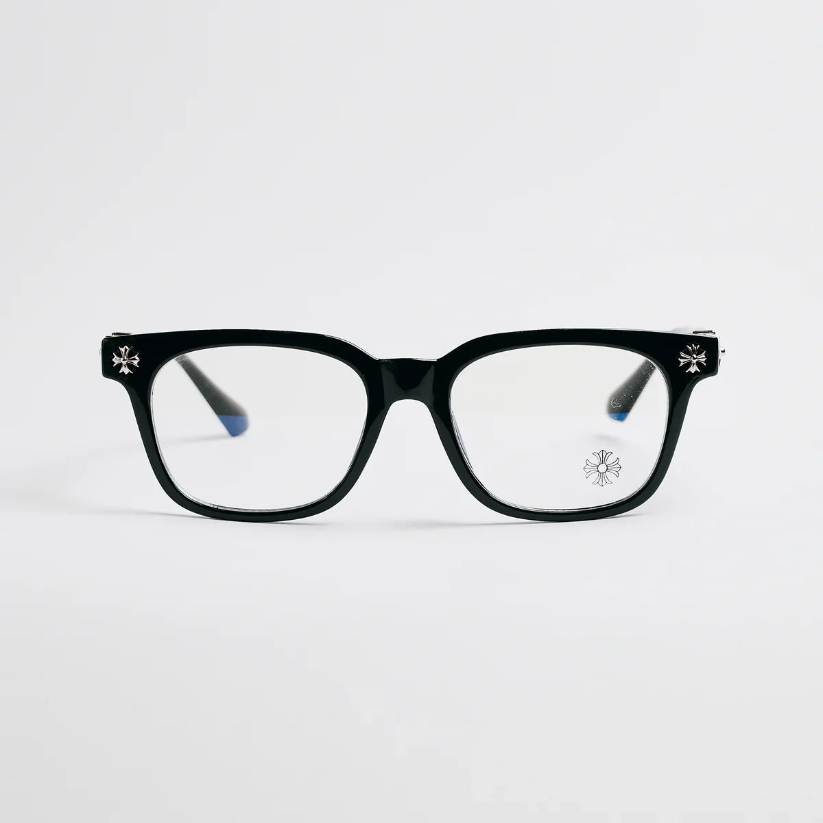 Black eyeglasses with decorative elements on a light gray background